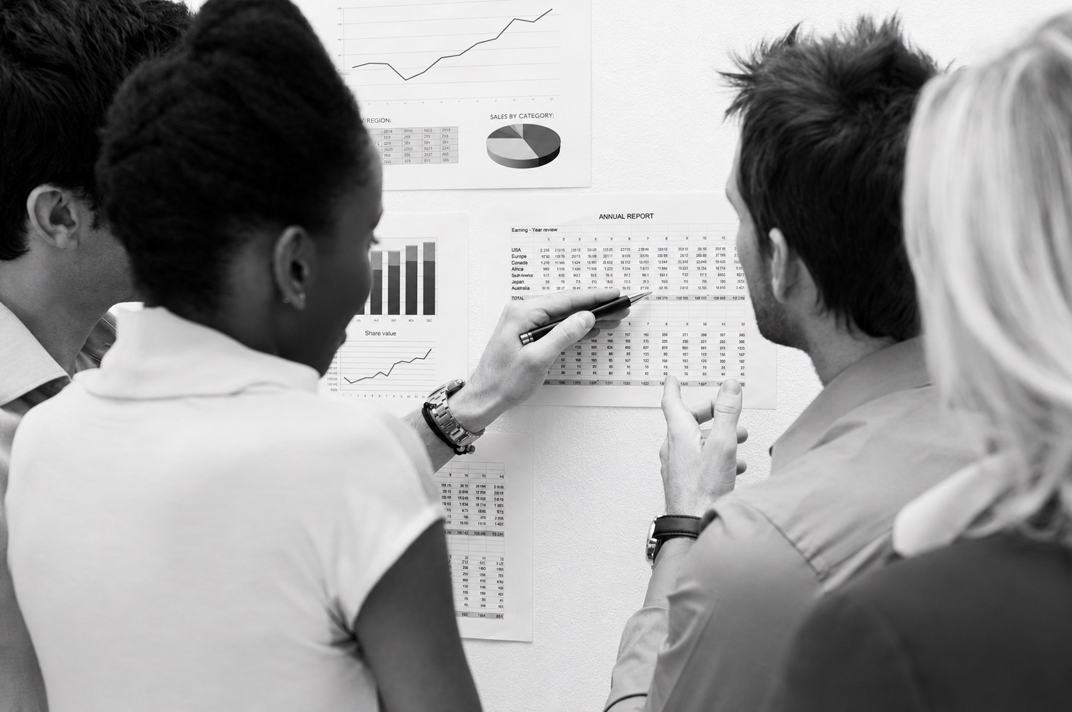 A startup team reviewing a comparison chart of software development agencies