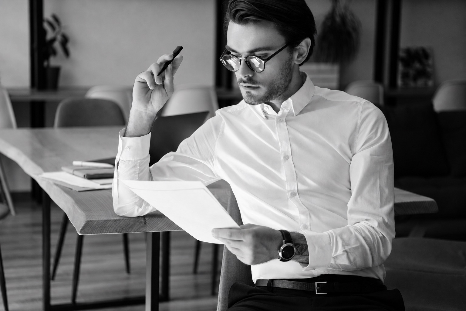 A founder carefully reviewing agency proposals and documents before making a hiring decision