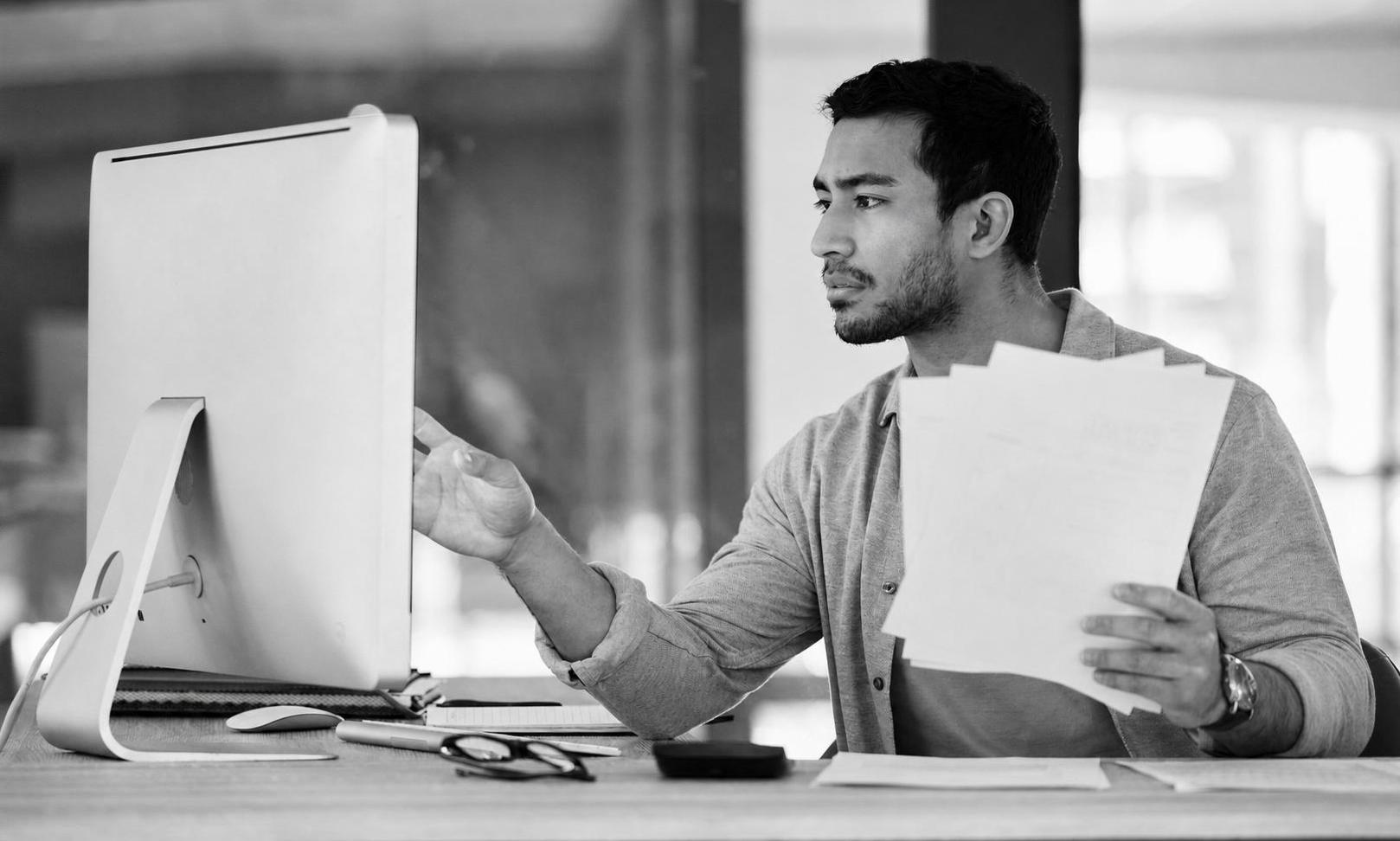 A developer reviewing an MVP scope document and feature list with a startup founder