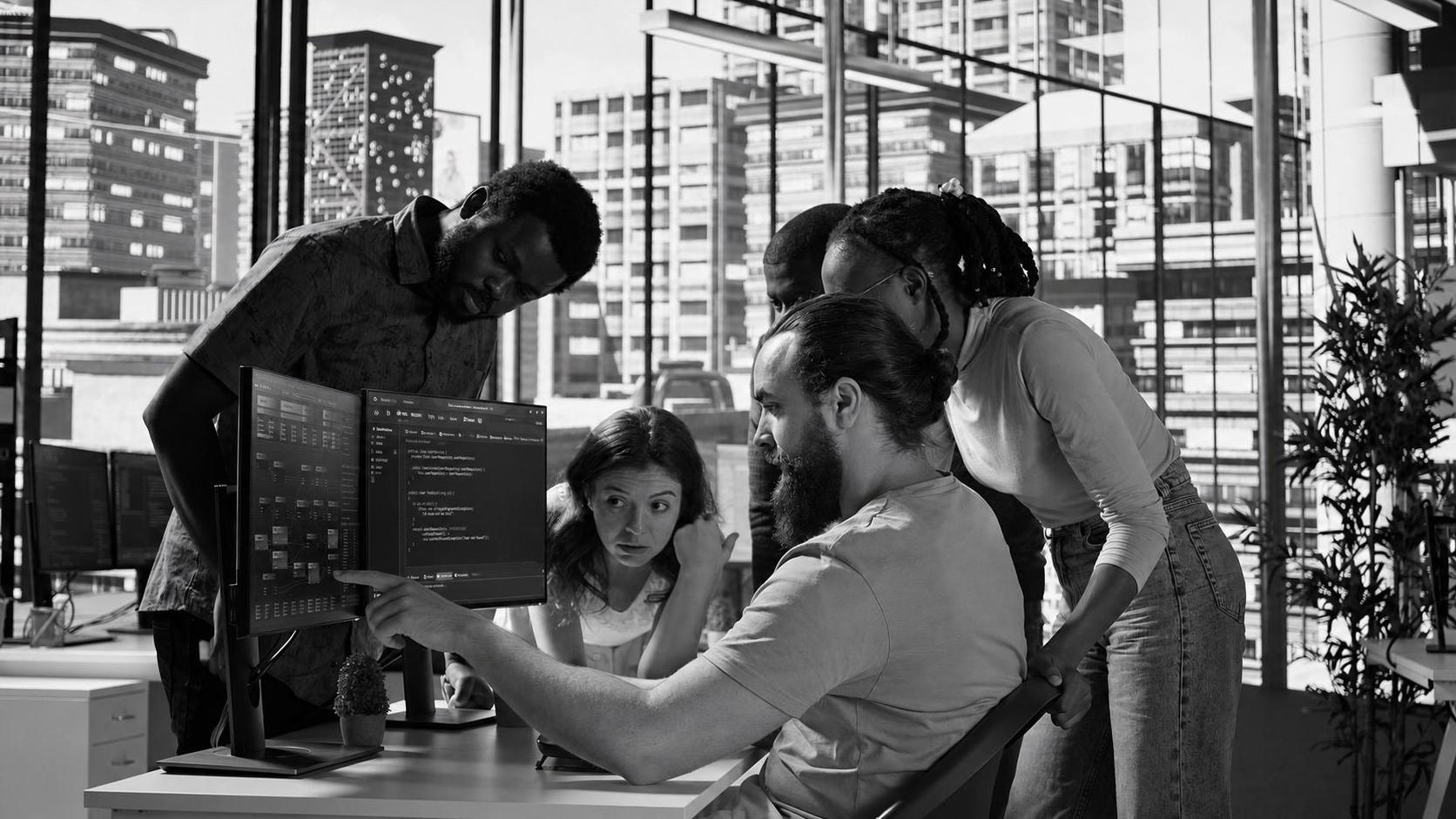 A software development team reviewing a staging environment build during a sprint
