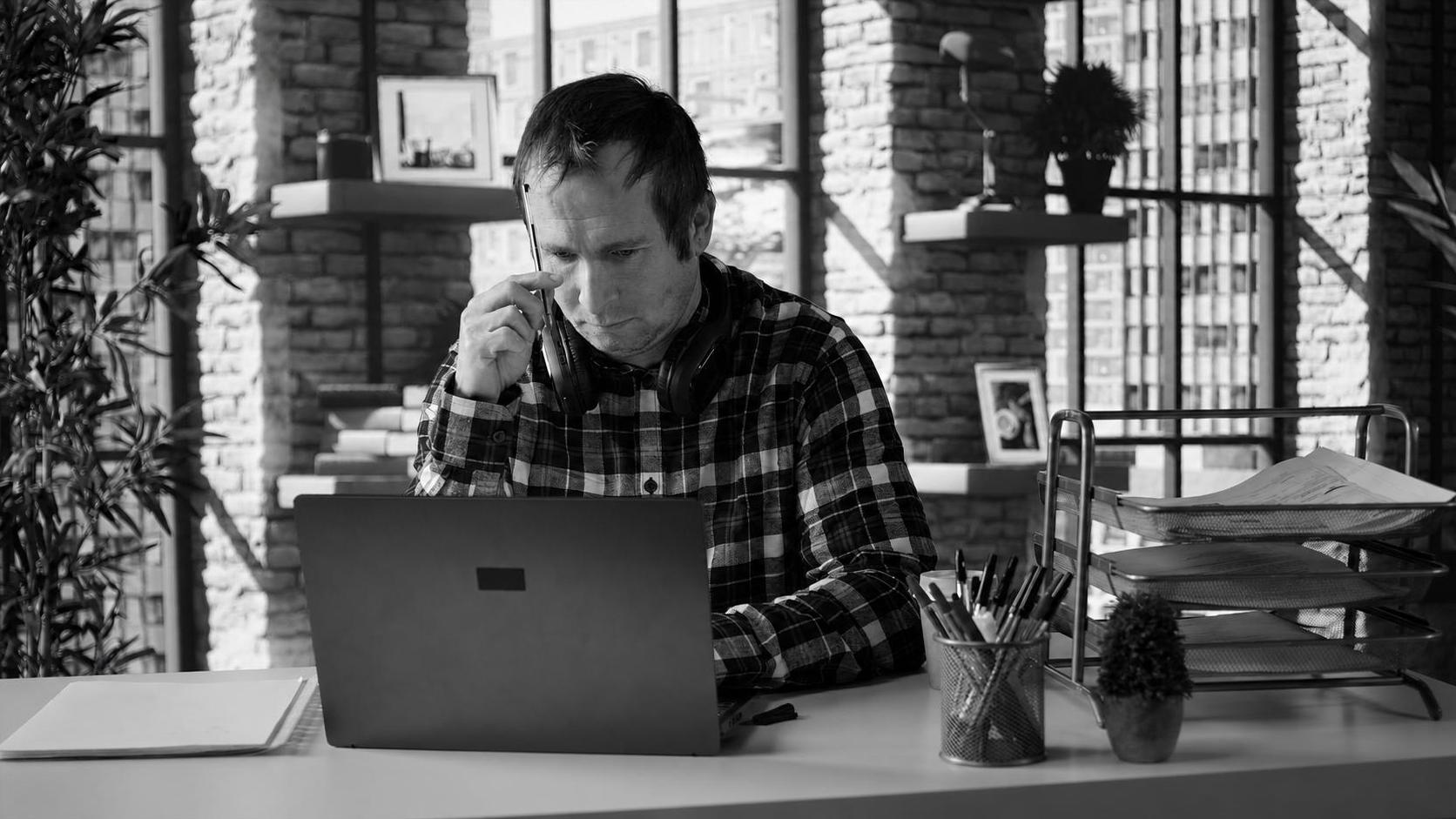 A non-technical founder looking stressed at a laptop, confronting unexpected problems mid-build