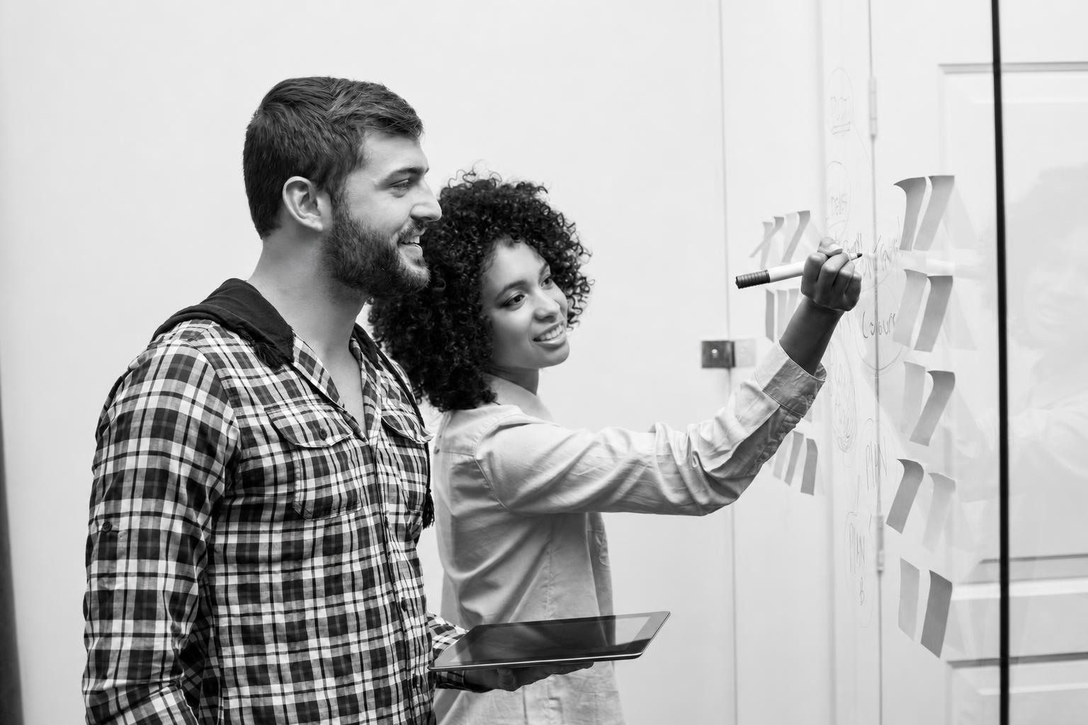 Product team comparing launch-critical features on a whiteboard